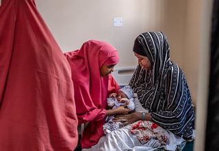 UNFPA trained midwife with a newborn baby at Banadir Hospital, Mogadishu