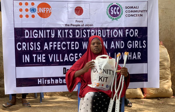 Maka Holds Her Dignity Kit During a Distribution Drive