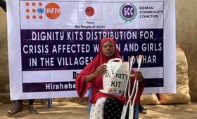 Maka Holds Her Dignity Kit During a Distribution Drive