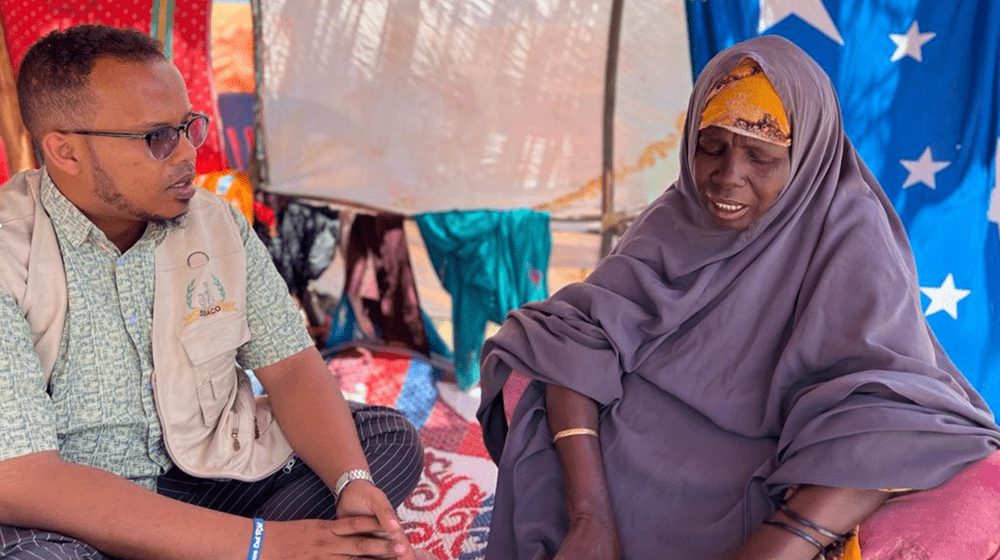 Nadifo with a SBACO Mobile Outreach team staff inside her IDP shelter